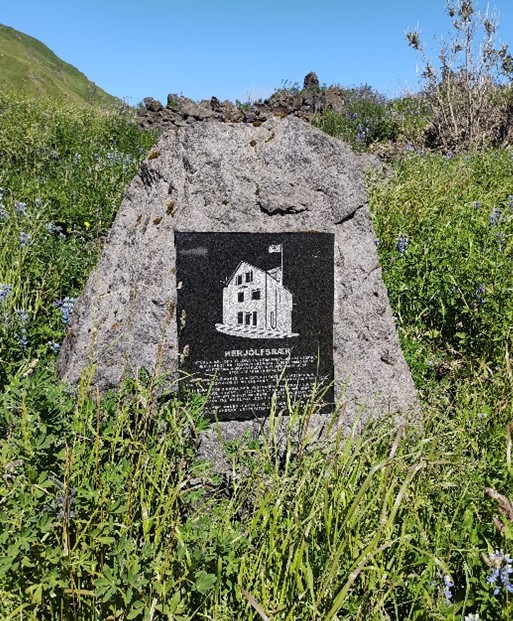 Stone memorial with drawing of a house