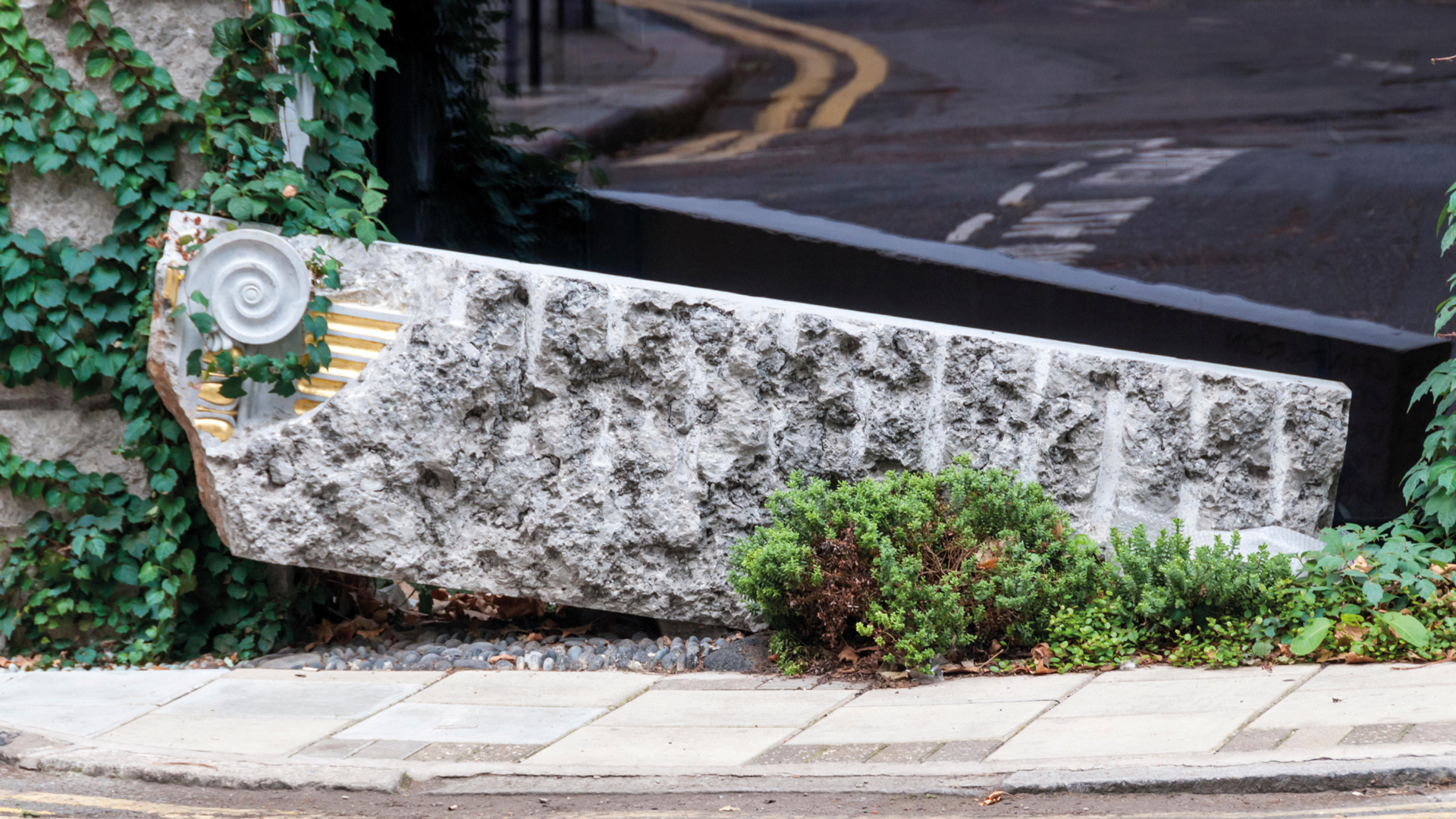 Carved stone covered with ivy