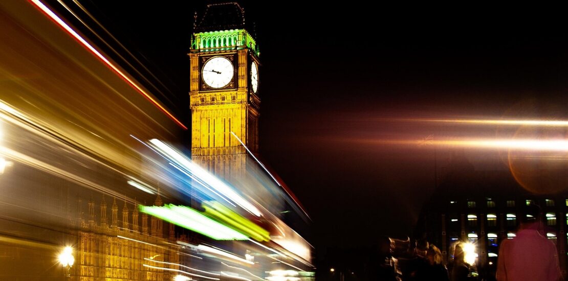 People and cars passing Big Ben clock tower in London